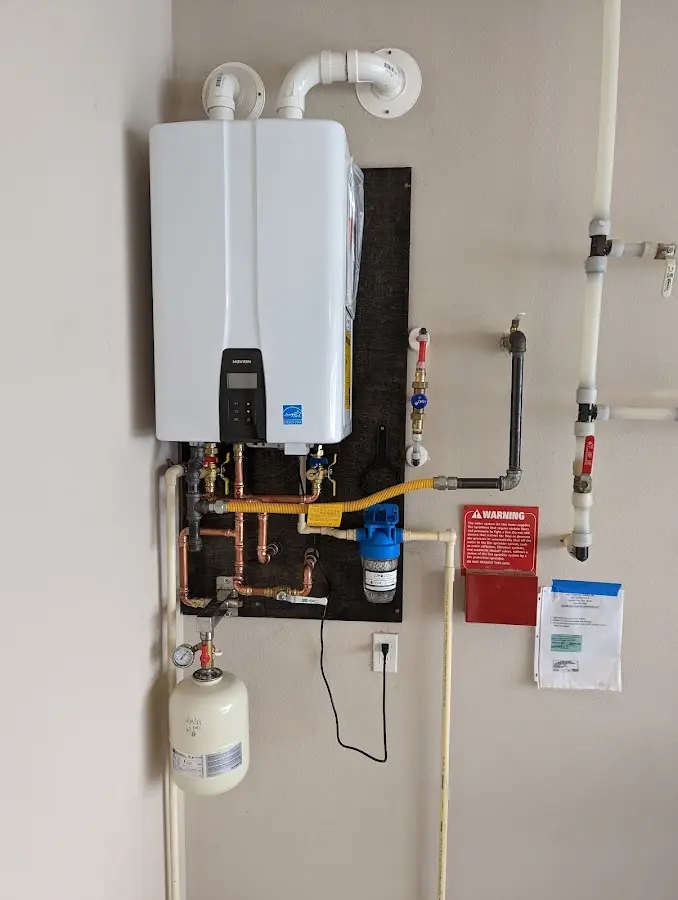 Professional plumber installing copper piping in a Potterville home